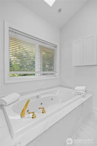 a bathroom with a bathtub and a window