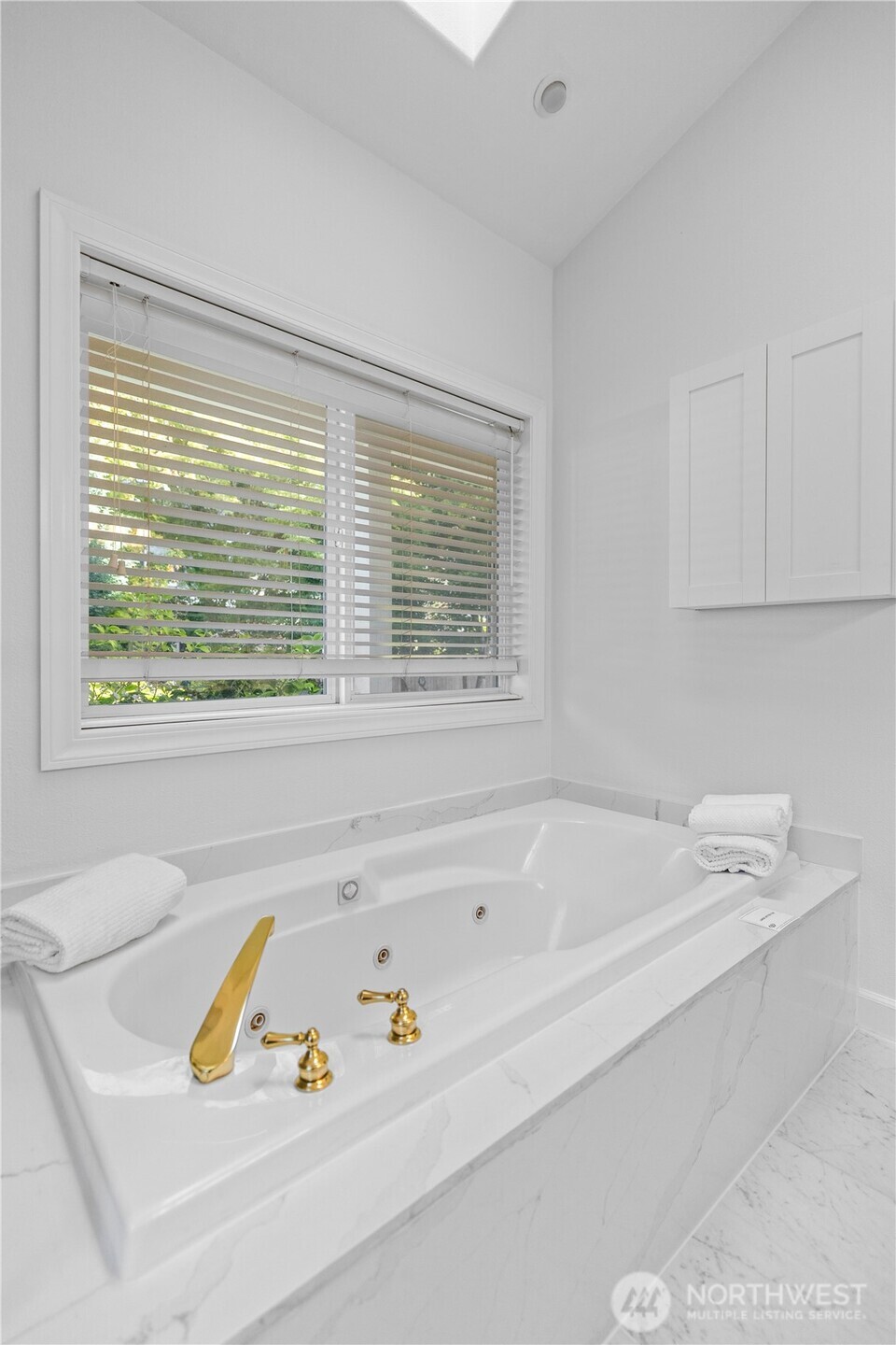 5217 76th Ave Court West University Place, WA 98467 - Photo 21 of 36 a bathroom with a bathtub and a window