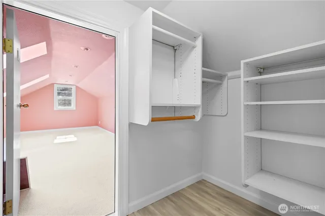 a view of walk in closet with empty racks