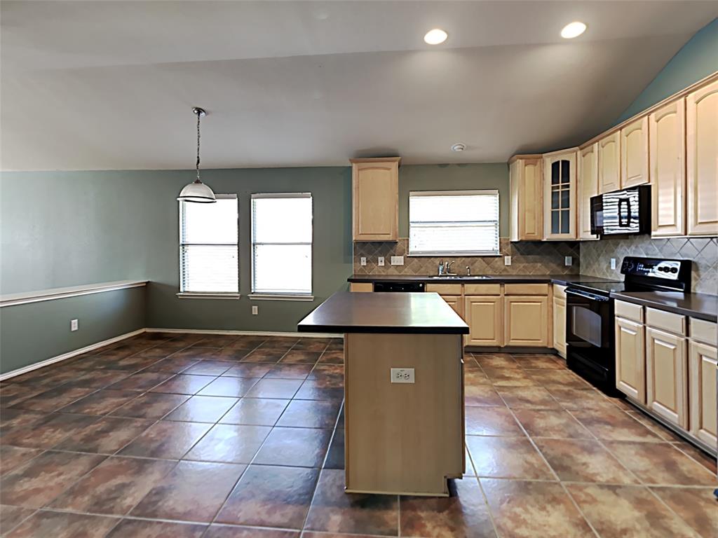 3251 Torio Grand Prairie, TX 75054 - Photo 5 of 17 a kitchen with stainless steel appliances granite countertop a stove a sink and a microwave