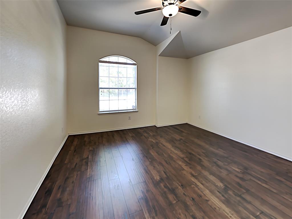 3251 Torio Grand Prairie, TX 75054 - Photo 7 of 17 an empty room with wooden floor chandelier fan and windows