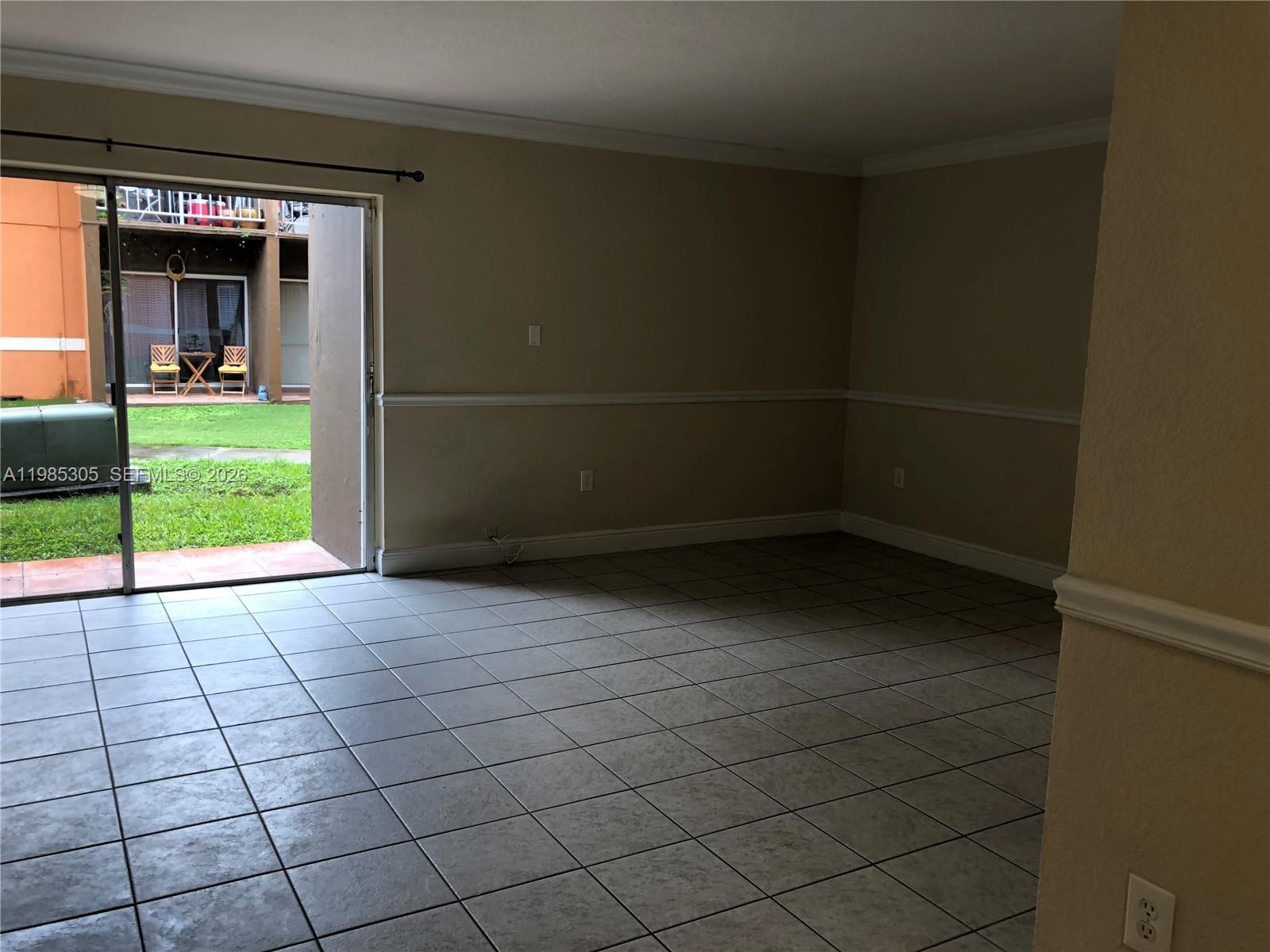 9467 Southwest 76th Street, Unit Q3 Miami, FL 33173 - Photo 11 of 18 a view of an empty room with a window