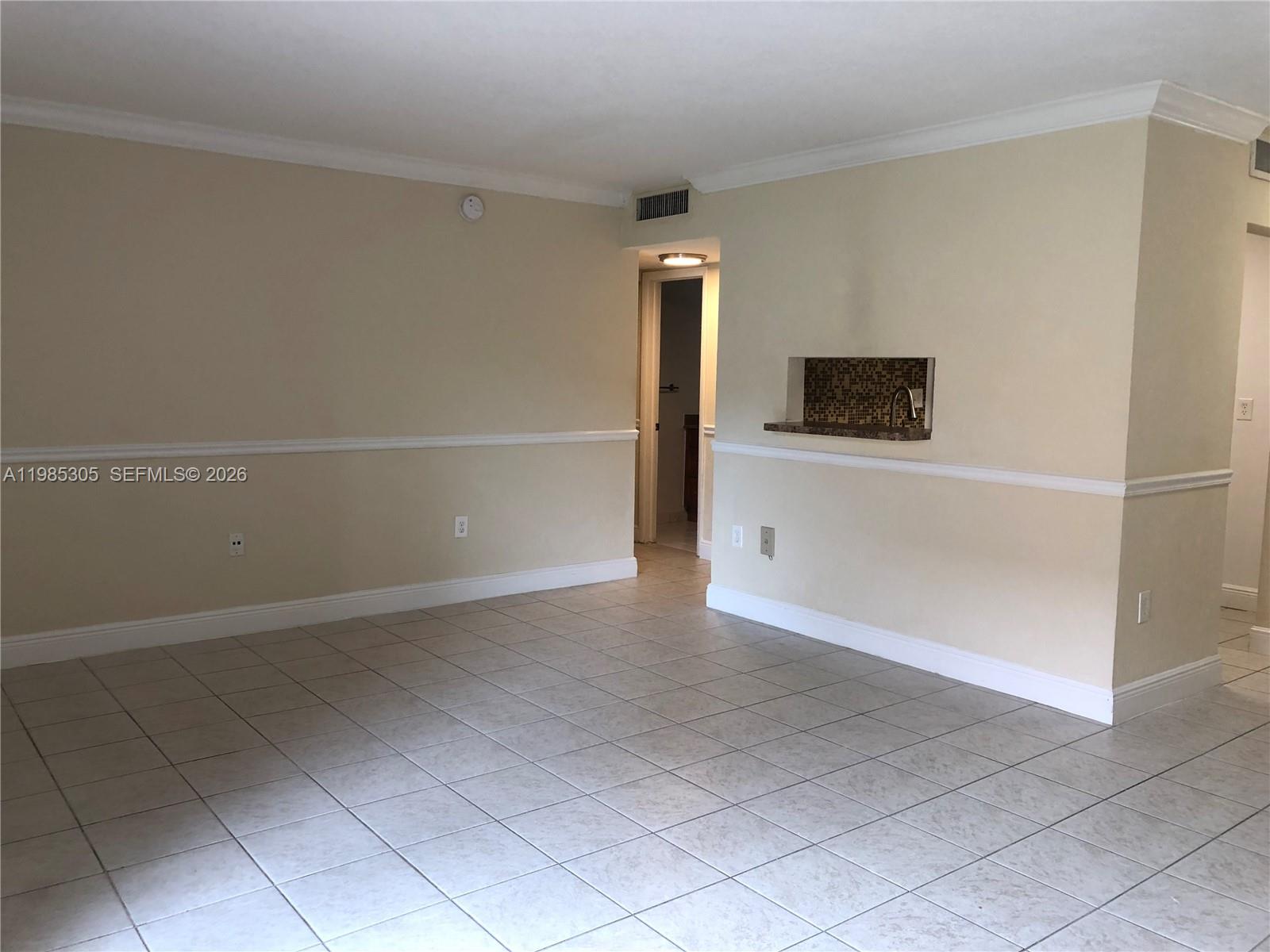 9467 Southwest 76th Street, Unit Q3 Miami, FL 33173 - Photo 8 of 18 an empty room with windows and fireplace