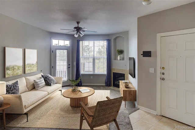 a living room with furniture a table and a large window