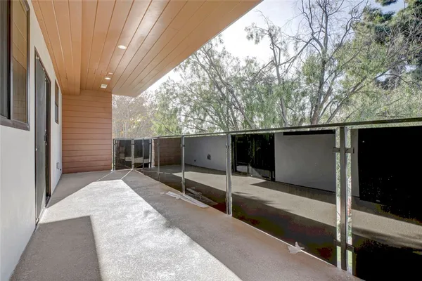 a backyard of a house with seating space and trees