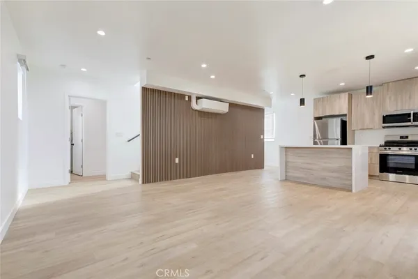 a view of kitchen with stainless steel appliances a refrigerator and microwave