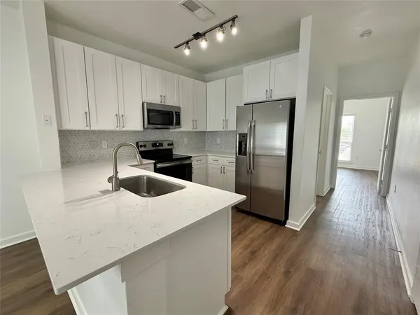 a kitchen with wooden cabinets and stainless steel appliances