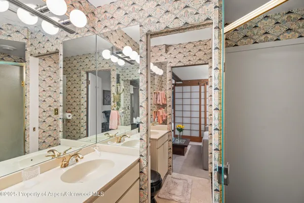 a bathroom with a sink vanity granite and a mirror
