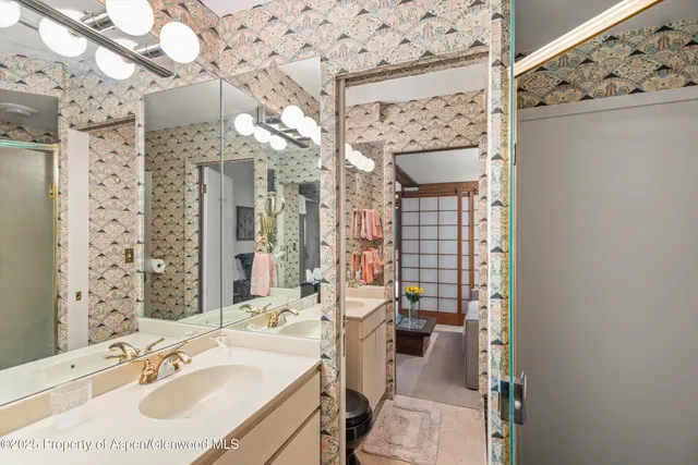 a bathroom with a sink vanity granite and a mirror