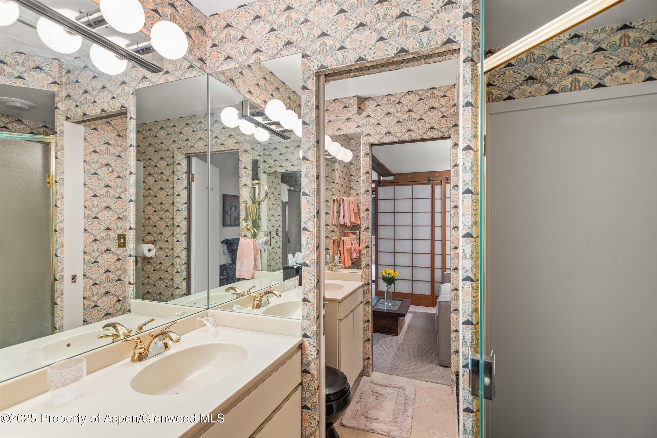 824 East Hopkins Avenue, Unit 102 AND 202 Aspen, CO 81611 - Photo 13 of 19 a bathroom with a sink vanity granite and a mirror