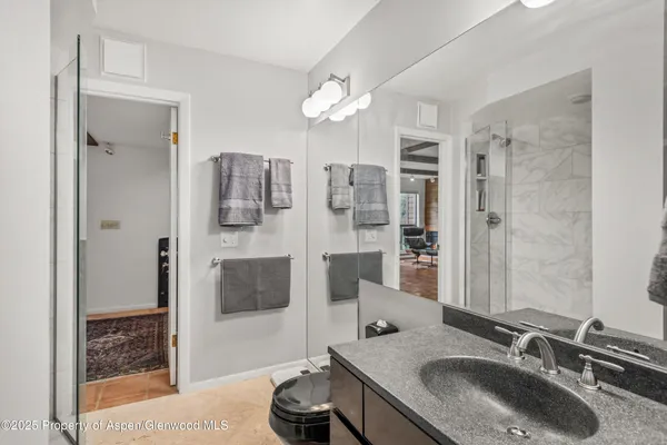 a bathroom with a sink double vanity and shower