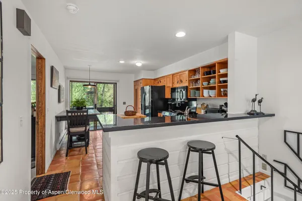a living room with furniture a flat screen tv and a large window