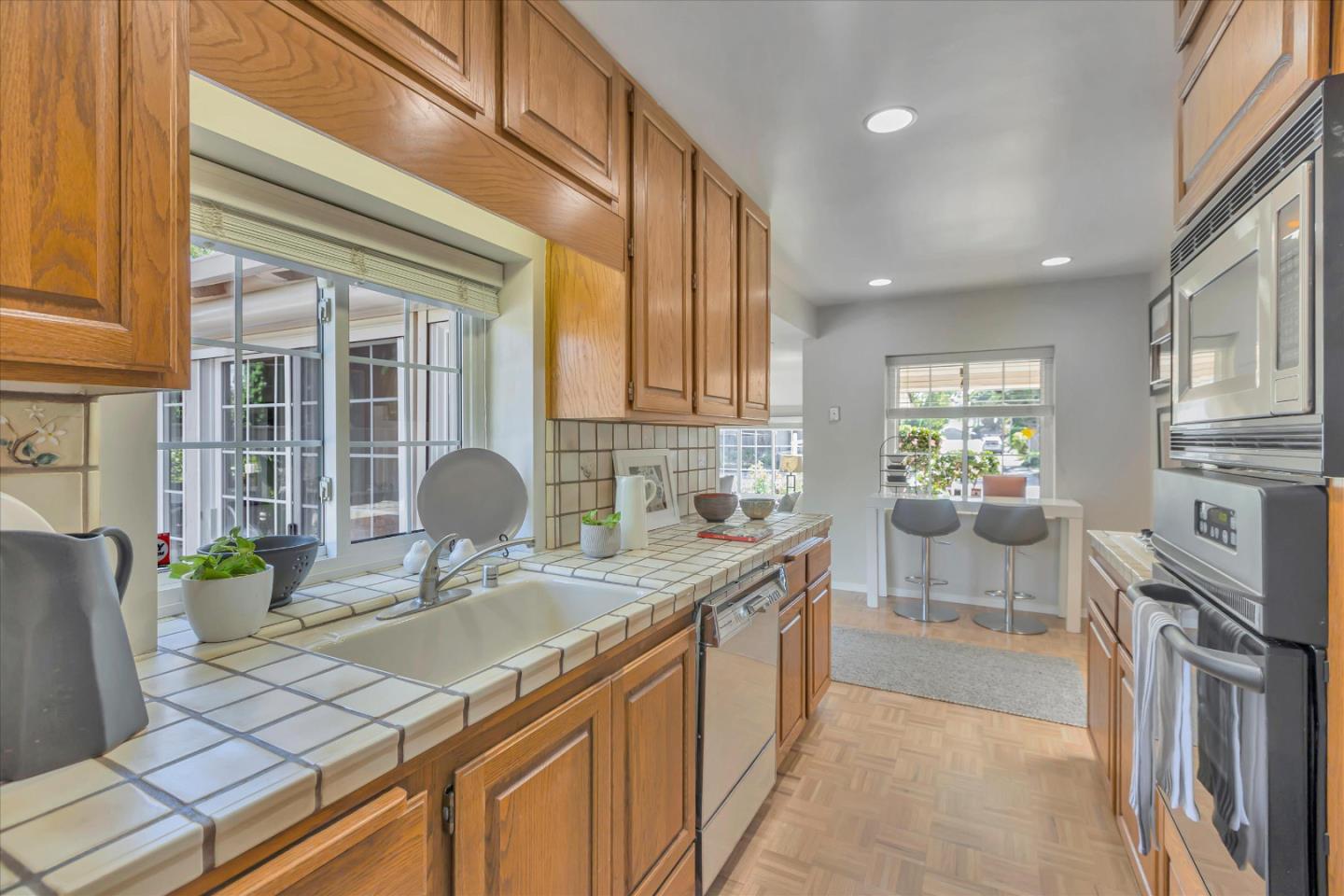1174 Fordham Way Mountain View, CA 94040 - Photo 11 of 36 a kitchen with granite countertop a sink and a stove top oven