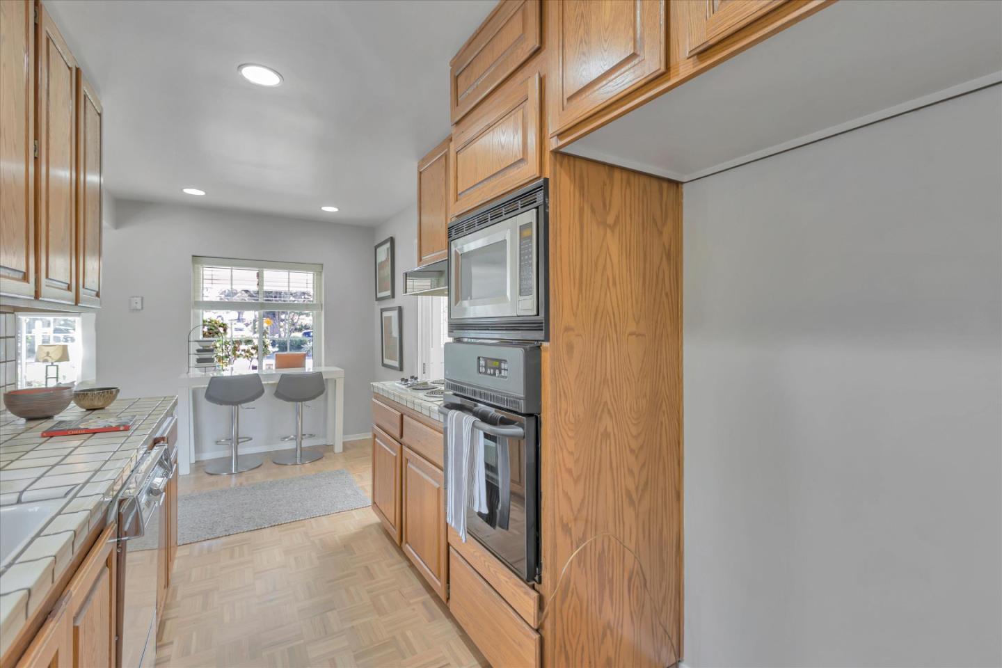 1174 Fordham Way Mountain View, CA 94040 - Photo 12 of 36 a kitchen with stainless steel appliances granite countertop a refrigerator and a stove top oven