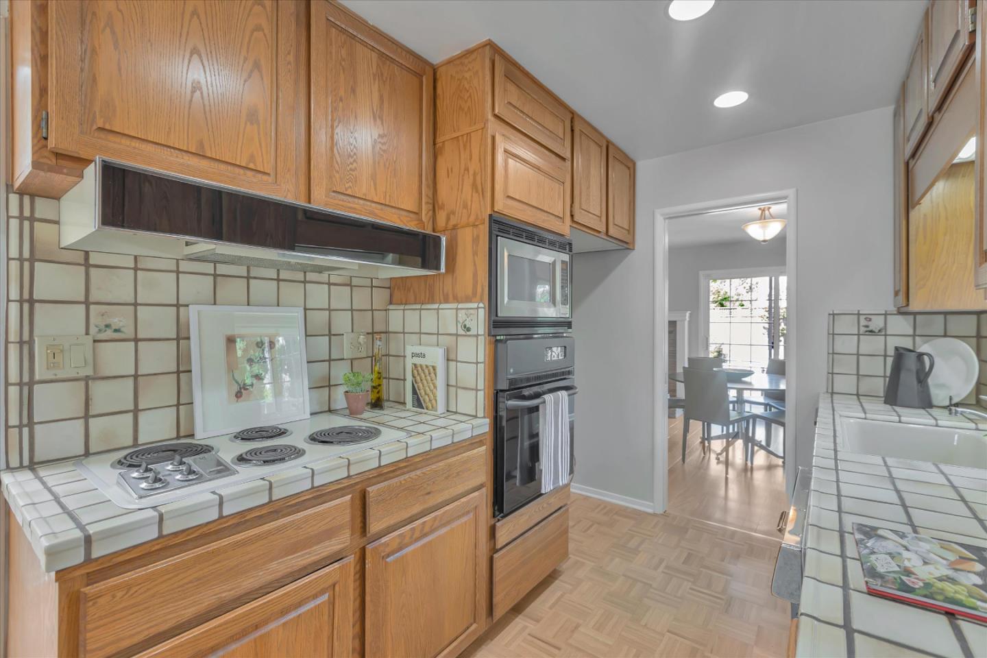 1174 Fordham Way Mountain View, CA 94040 - Photo 14 of 36 a kitchen with kitchen island granite countertop a sink stove and cabinets