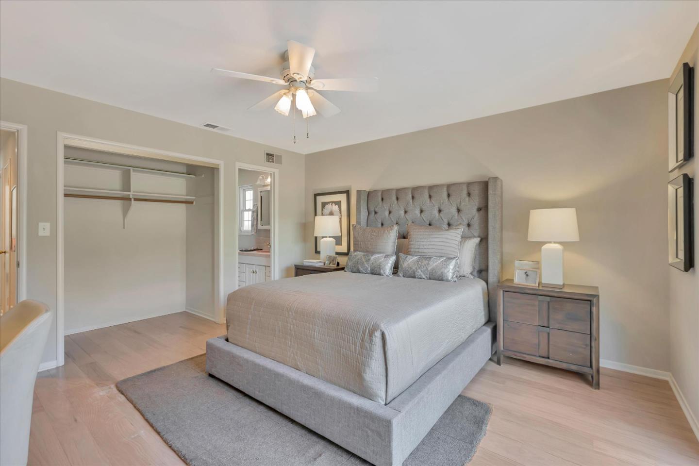 1174 Fordham Way Mountain View, CA 94040 - Photo 25 of 36 a bedroom with a large bed and a chandelier