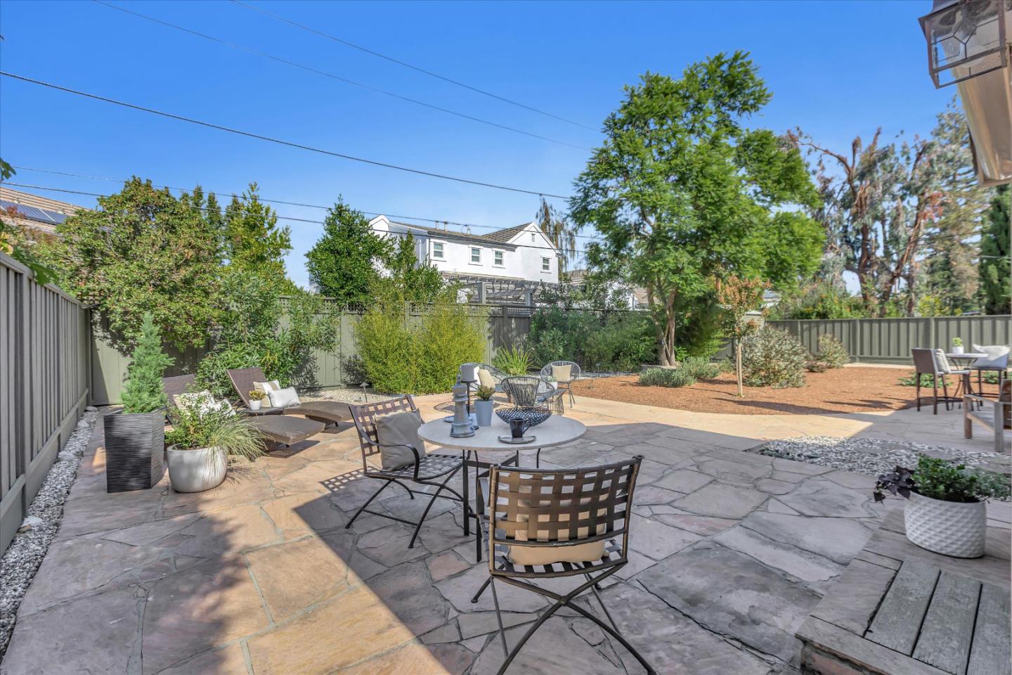 1174 Fordham Way Mountain View, CA 94040 - Photo 35 of 36 a view of a patio with dining table and chairs and potted plants