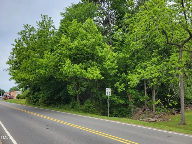 a view of a field with trees in the background