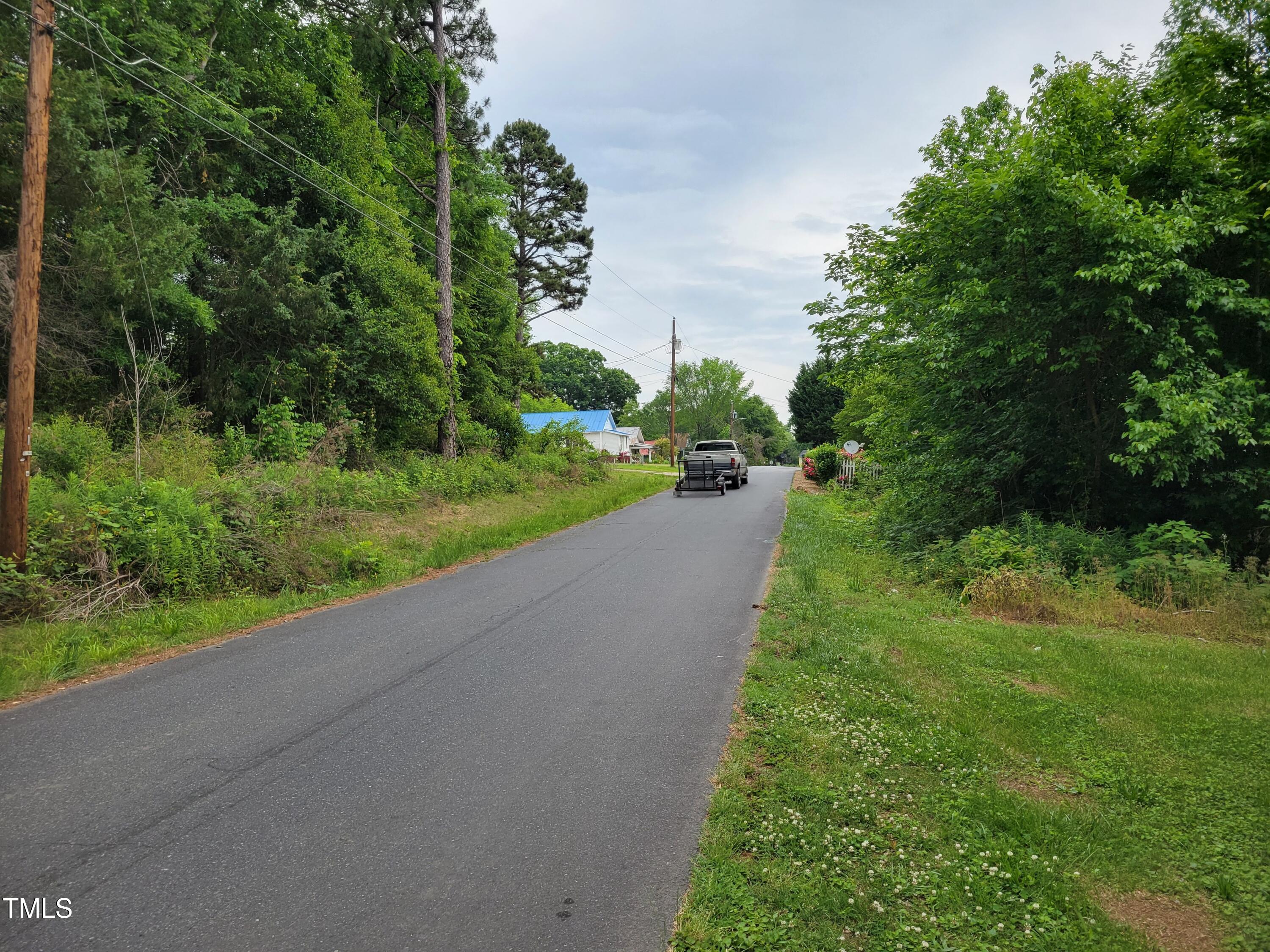 Tbd East 3rd Street Siler City, NC 27344 - Photo 19 of 23 a view of a road with a yard and a large trees