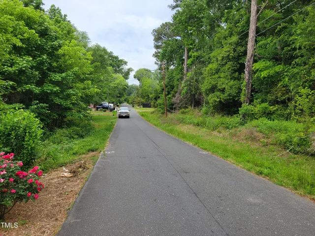an aerial view of residential house with outdoor space and trees all around