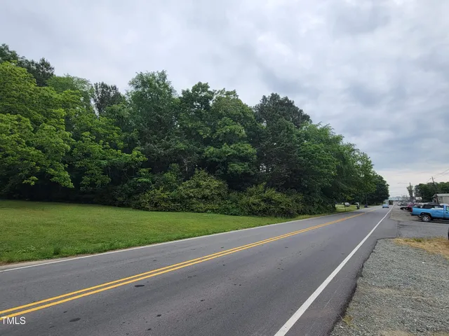 a view of a field with a trees in the background
