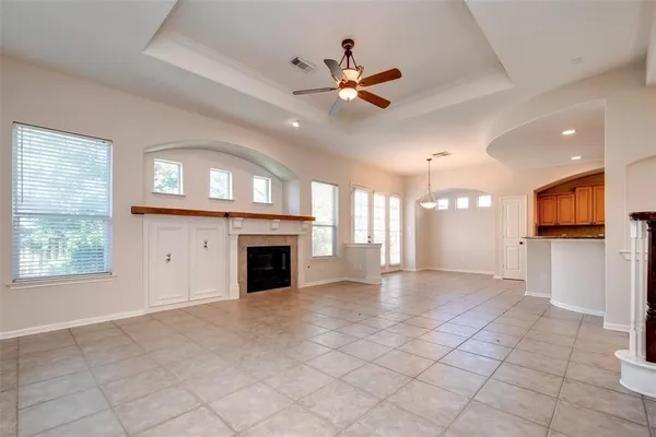 a view of an empty room with a fireplace and a window