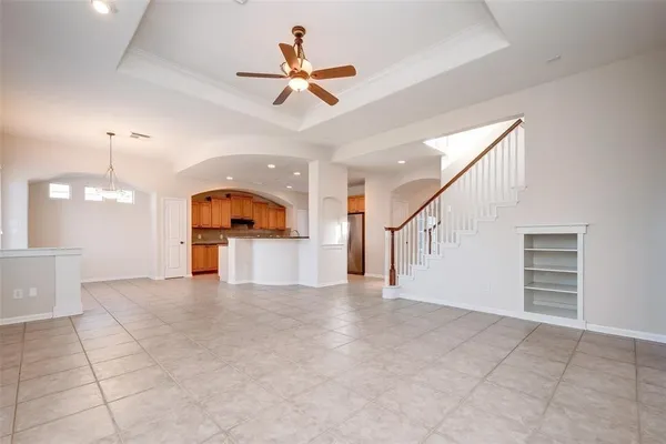 a view of a livingroom with a ceiling fan and entryway