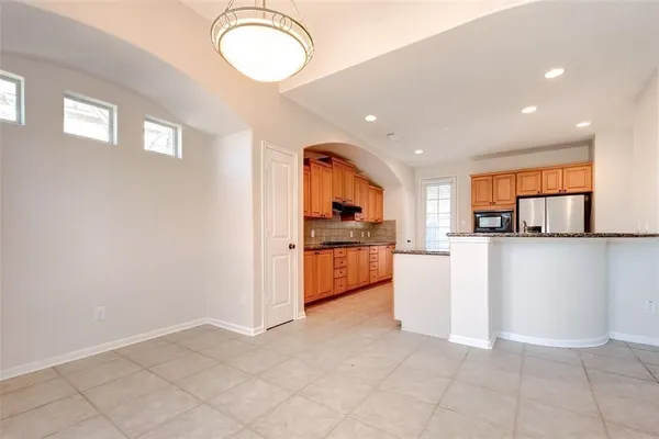 a kitchen with white cabinets and appliances