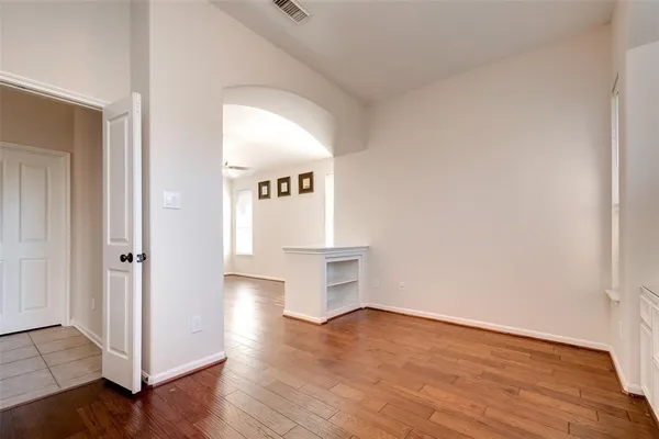 a view of an empty room and wooden floor
