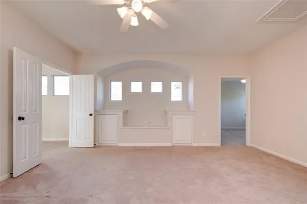 an empty room with windows and closet