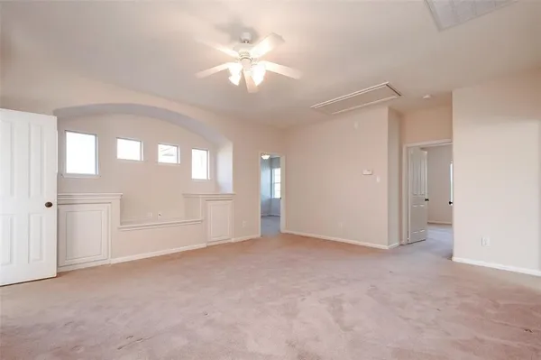 an empty room with windows and entrance