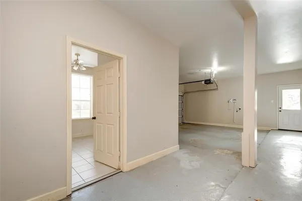 an empty room with windows and entrance