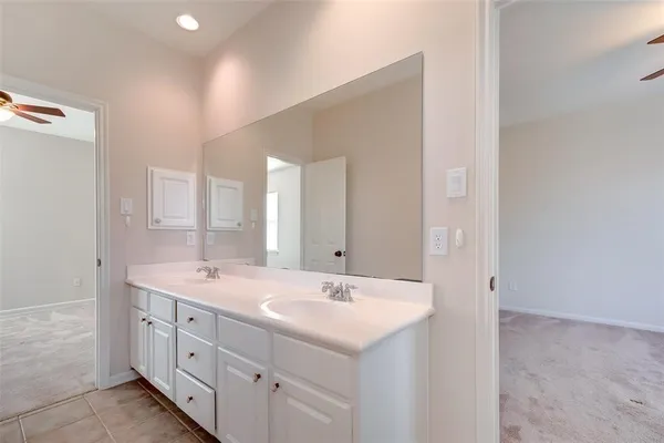 a bathroom with double sink and a mirror