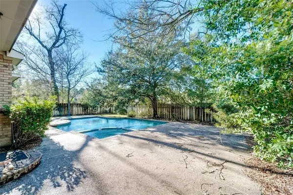 a view of backyard with large trees