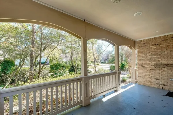 a view of a porch with a floor to ceiling window and wooden floor