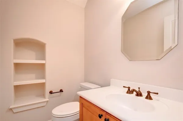 a bathroom with a sink a toilet and mirror