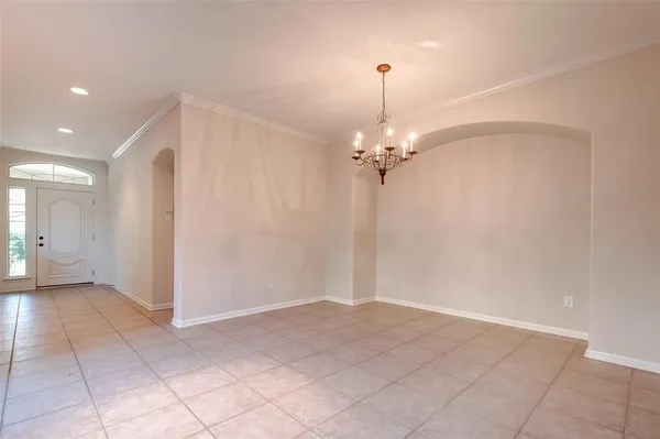 a view of a chandelier fan and entryway