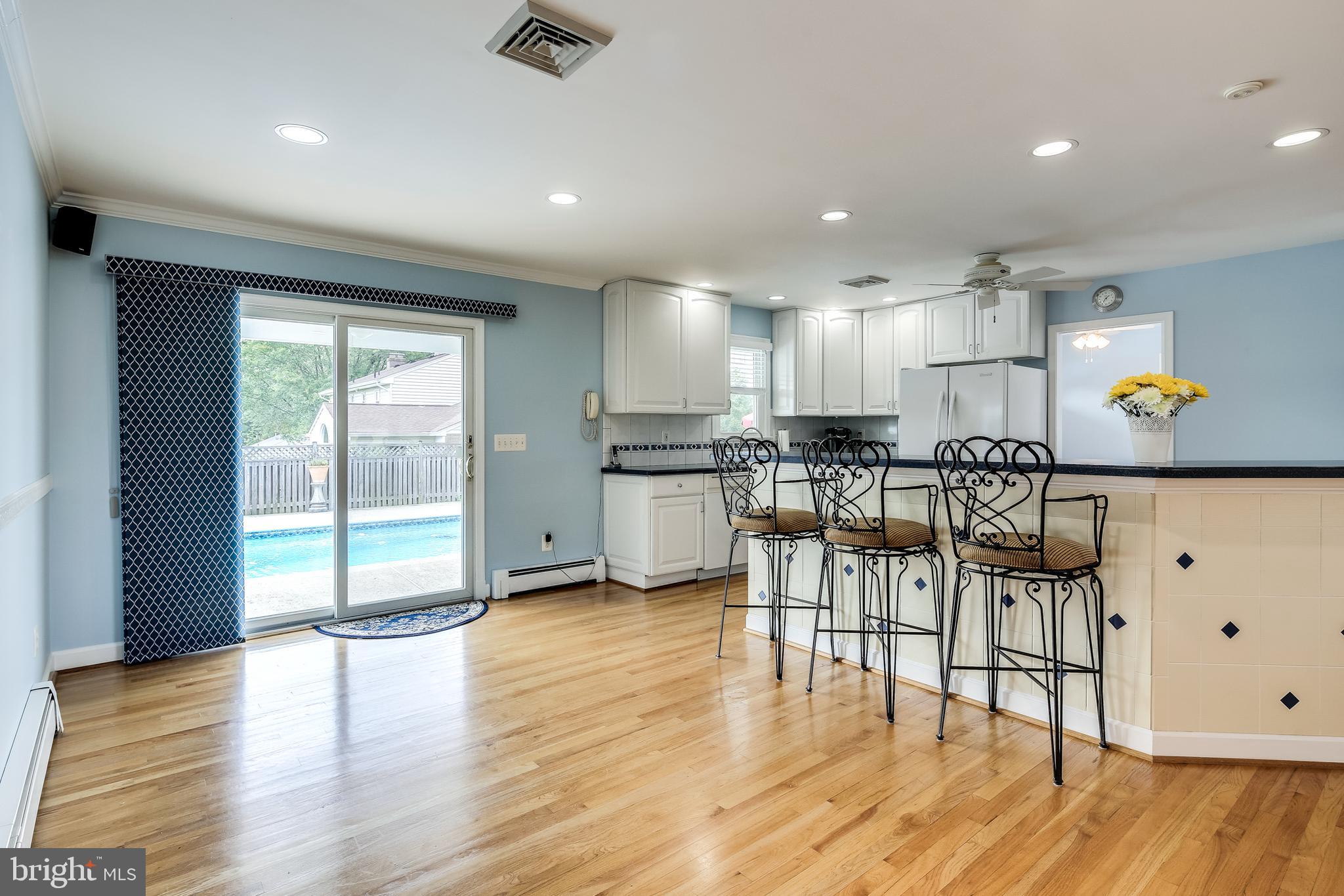 22720 Woodfield Road Gaithersburg, MD 20882 - Photo 11 of 39 Kitchen bar and table space overlooking pool area.