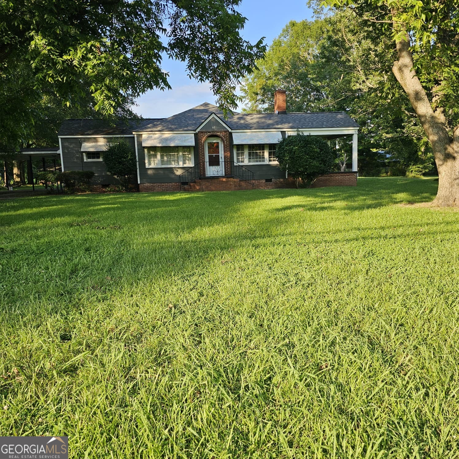 60 North East Main Street Hampton, GA 30228 - Photo 2 of 17 a front view of a house with a yard