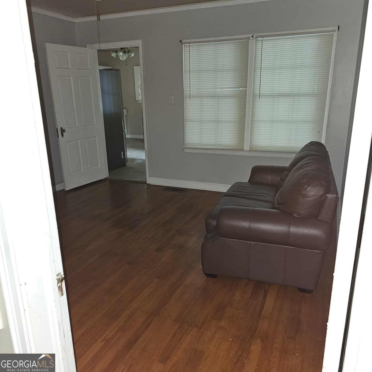 60 North East Main Street Hampton, GA 30228 - Photo 3 of 17 a living room with furniture and a window