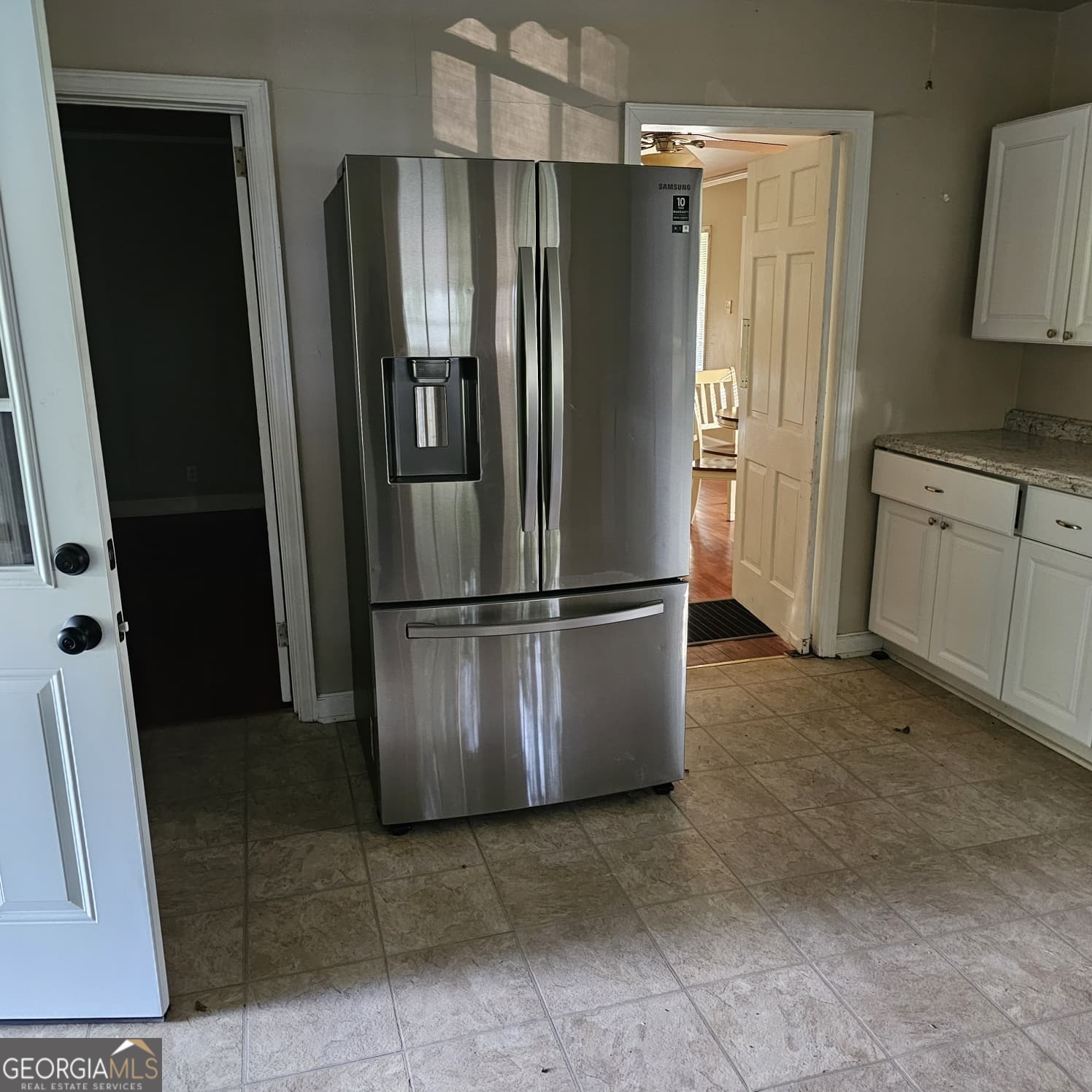 60 North East Main Street Hampton, GA 30228 - Photo 4 of 17 a kitchen with stainless steel appliances granite countertop a refrigerator and a sink