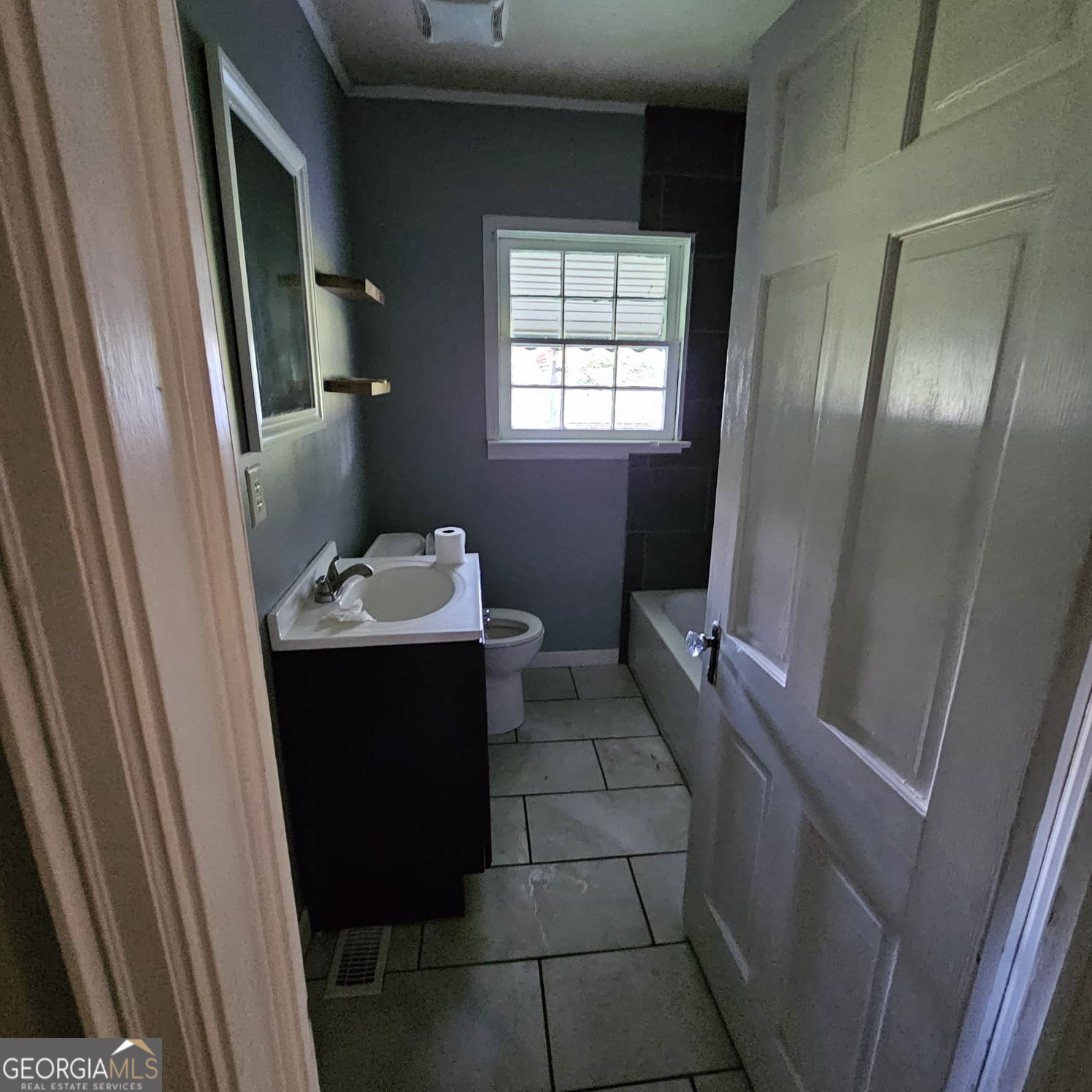 60 North East Main Street Hampton, GA 30228 - Photo 6 of 17 a bathroom with a sink and mirror