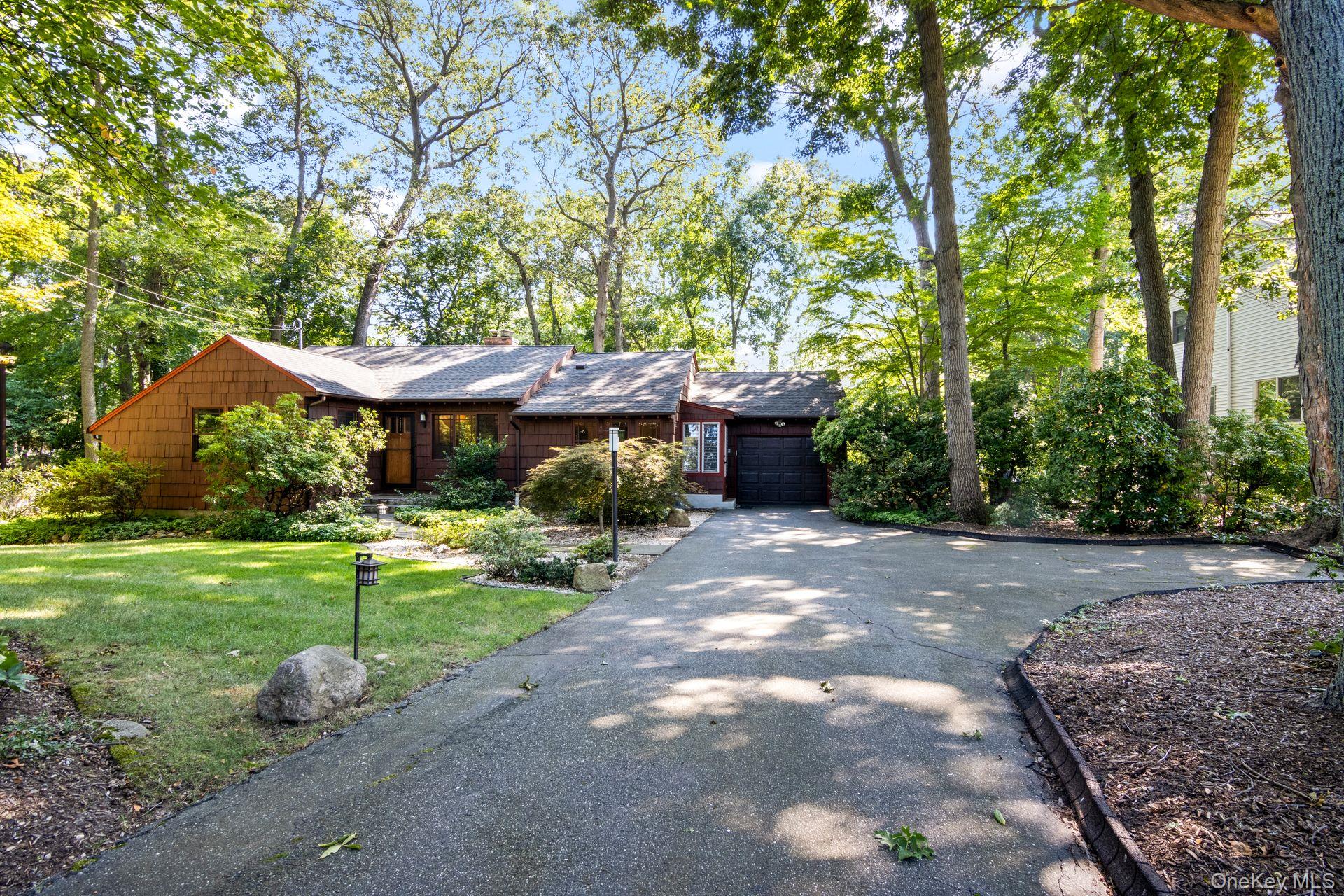 a view of a yard with a table and chairs under an umbrella