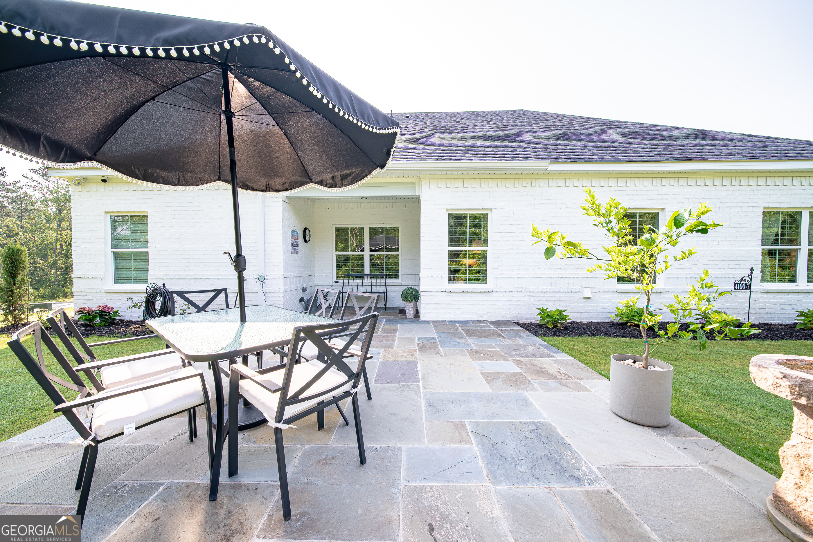 96 Cypress Trail Fortson, GA 31808 - Photo 11 of 62 a view of a patio with chairs and table under an umbrella