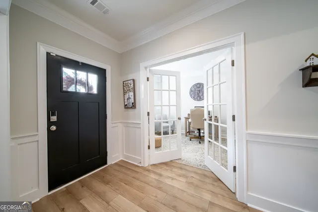a view of a dining room with furniture and chandelier