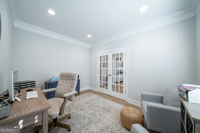 a open kitchen with stainless steel appliances kitchen island granite countertop a sink and white cabinets with wooden floor