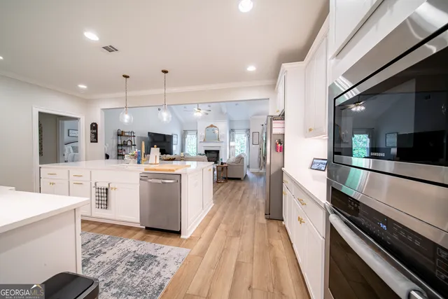 a kitchen with stainless steel appliances kitchen island a refrigerator sink and stove