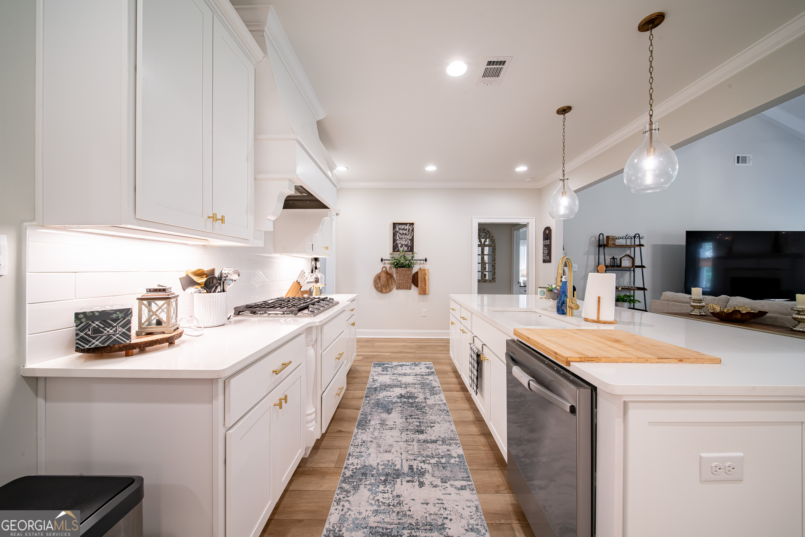 96 Cypress Trail Fortson, GA 31808 - Photo 20 of 62 a open kitchen with stainless steel appliances kitchen island granite countertop a sink and white cabinets with wooden floor