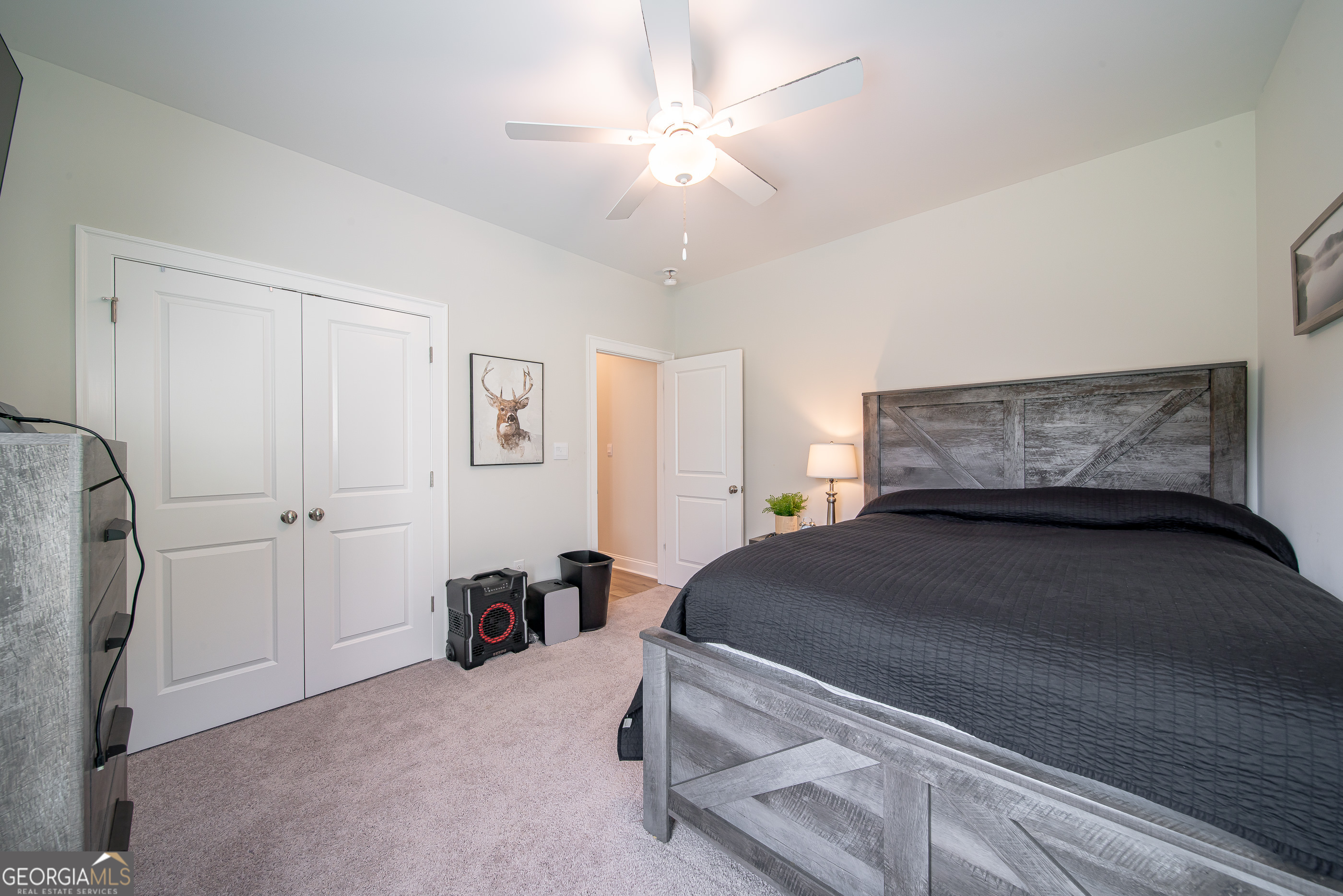 96 Cypress Trail Fortson, GA 31808 - Photo 35 of 62 a bedroom with a bed and a chandelier