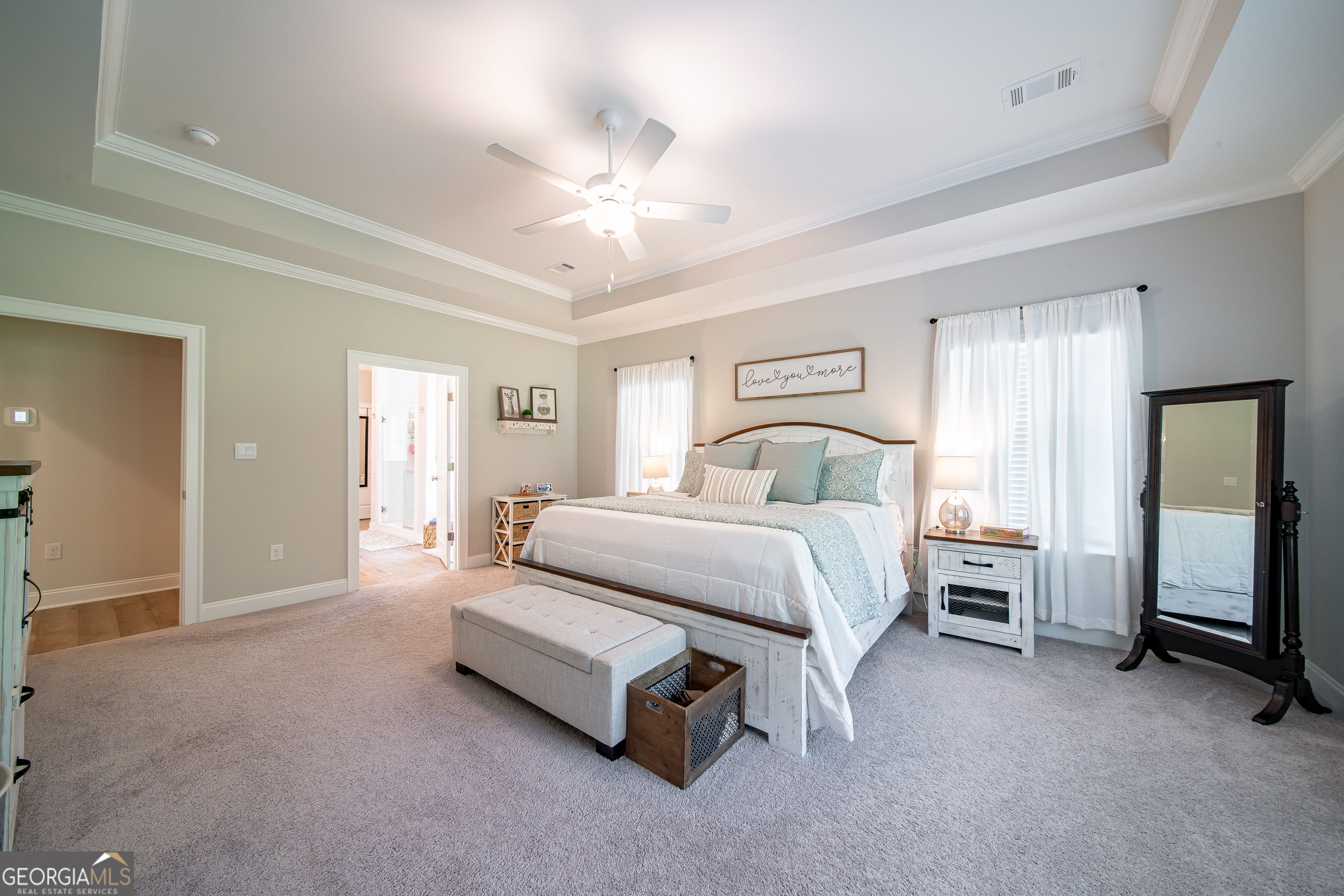 96 Cypress Trail Fortson, GA 31808 - Photo 38 of 62 a spacious bedroom with a bed and a chandelier